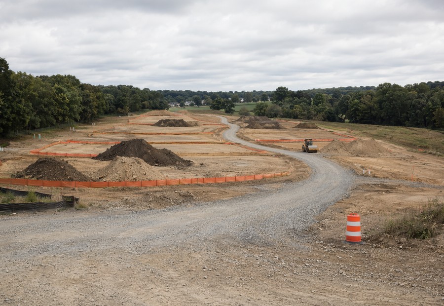 Graded residential subdivision lots with topsoil stockpiles